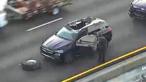 Loose Tire Hits SUV